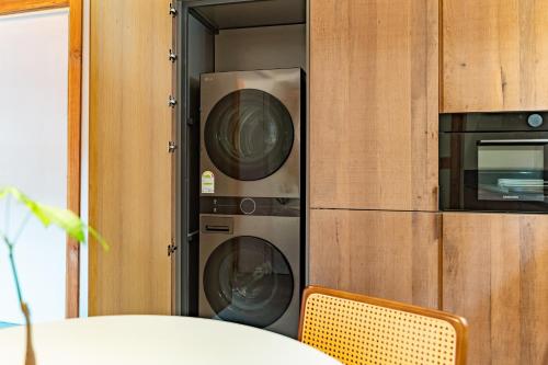 two washer and dryers are in a wall at Gyedong Hanok 125 in Seoul