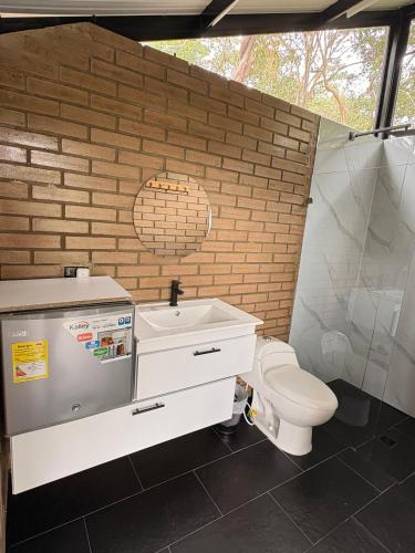 a bathroom with a toilet and a sink at Glamping REFUGIO Guadalajara Glamping in Moniquirá