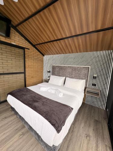 a bedroom with a large white bed in a room at Glamping REFUGIO Guadalajara Glamping in Moniquirá