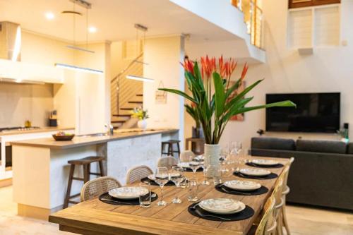 a wooden table with wine glasses on it in a living room at Villa Amalfi - Port Douglas in Port Douglas
