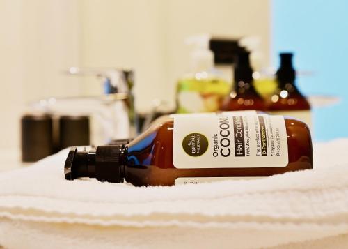 a bottle of alcohol sitting on top of a towel at Coconut Lane Bangkok in Bangkok