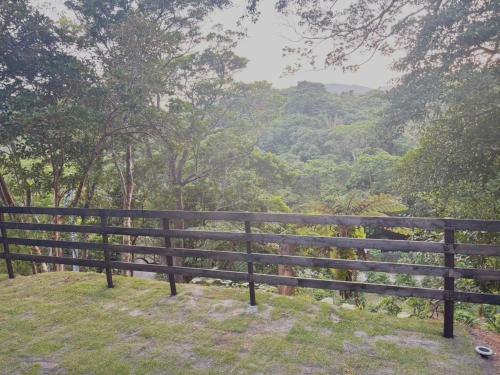 a wooden fence with a view of a forest at GLAMFOREST Okinawa 名護 in Nago