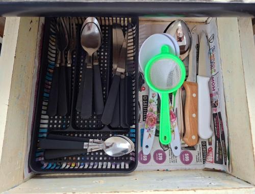 a drawer filled with utensils in a box at Homekey Studio Apartment in Nadi