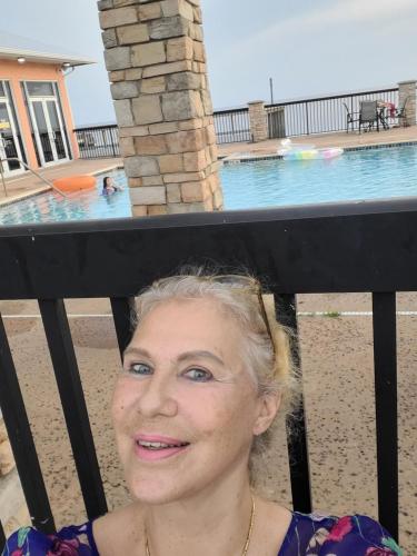 a woman standing in front of a swimming pool at LakeOkechobeFishingfrm22DaylyfourprsMinPartyPerRoom in Pahokee