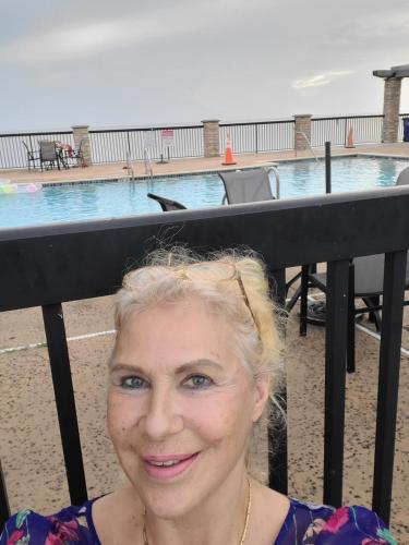 a woman standing in front of a swimming pool at LakeOkechobeFishingfrm22DaylyfourprsMinPartyPerRoom in Pahokee