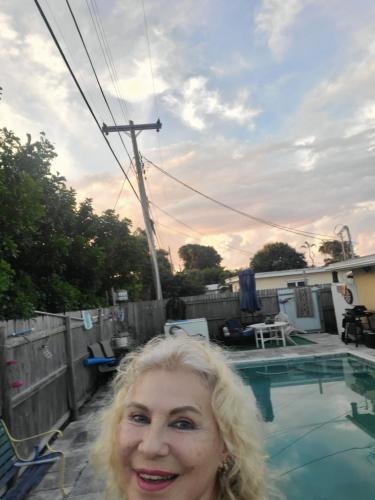 a woman standing in front of a swimming pool at LakeOkechobeFishingfrm22DaylyfourprsMinPartyPerRoom in Pahokee