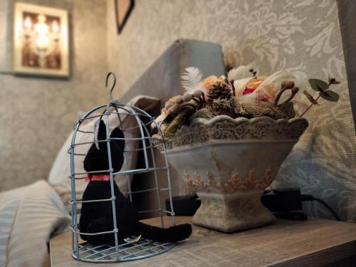 a stuffed animal sitting on a table next to a vase at Nagoya Apricot House Entire Villa in Nagoya