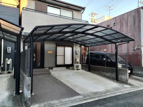 a parking lot with a large metal structure at Nagoya Apricot House Entire Villa in Nagoya