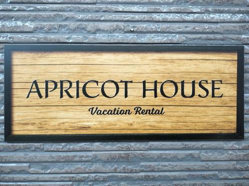a sign for araport house on a brick wall at Nagoya Apricot House Entire Villa in Nagoya