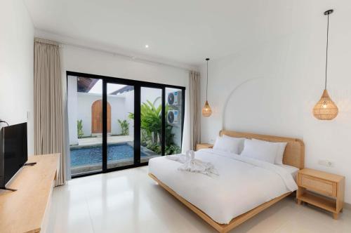 Ένα ή περισσότερα κρεβάτια σε δωμάτιο στο Avura Villa Munggu