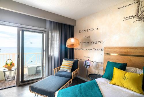 a bedroom with a bed and a view of the ocean at Fort Young Hotel in Roseau