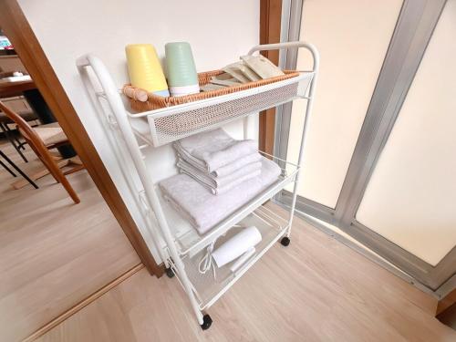 a towel cart with towels and other items on it at 海しずくLittle in Kami Amakusa