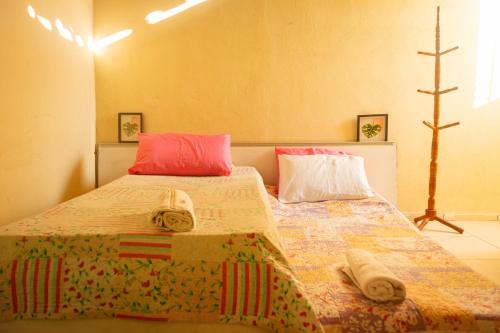 a bedroom with two beds with towels on them at Casa de Hospedagem Cajueiro in Jijoca de Jericoacoara