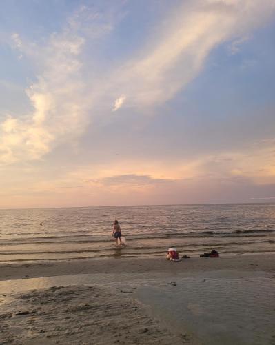 a person walking on the beach near the ocean at PalmBeachHousefrom69DaylyforPrsmin2PersPPartyP3rRoom in West Palm Beach