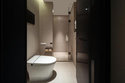 a bathroom with a white toilet and a shower at Atour Hotel Shanghai The Bund Yuyuan Subway Station in Shanghai