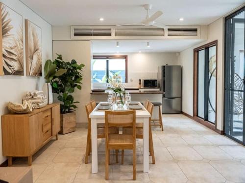 a kitchen and dining room with a table and chairs at 25 Solander Boulevard - Seashells, Port Douglas in Port Douglas
