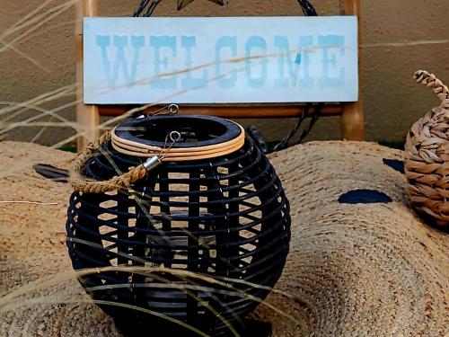 a black vase with a sign in the background at Nefeli Villa lagonisi - Pool in Lagonissi