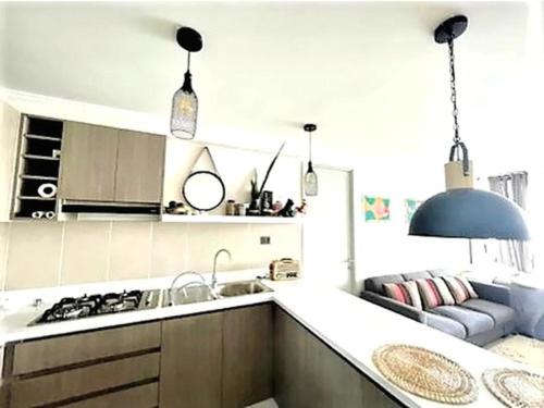 a kitchen with a sink and a stove top oven at Cómodo departamento céntrico in Arica