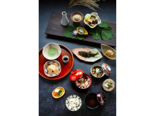 a table with plates of food and a cup of coffee at THE LAKE Kawaguchiko-kurashi in Fujikawaguchiko