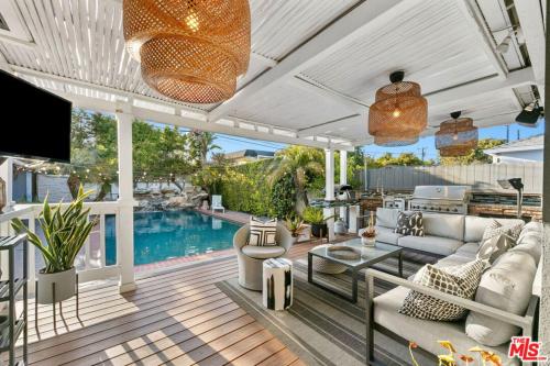 a living room with a couch and a table and a pool at The Palomino - AMAZING Chic-Luxe, Private, Guest House - Pool, Sauna, Free Parking in Los Angeles