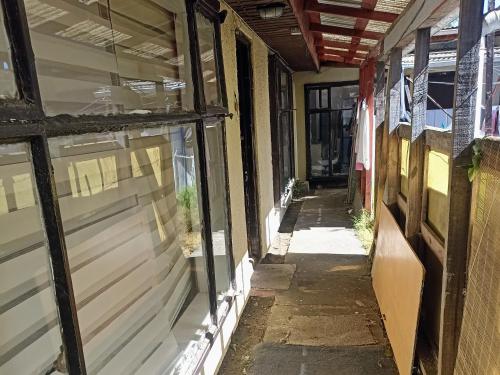 an empty alleyway in an old building with windows at Hostal Antonio Varas in Concepción