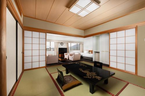 a room with a bedroom with a bed and a table at Grand Mercure Nara Kashihara in Kashihara