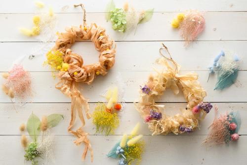 a wreath on a white wall with different types of feathers at Grand Mercure Nara Kashihara in Kashihara