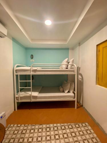a room with two bunk beds in a room at Wonderloft Hostel Jogja in Yogyakarta
