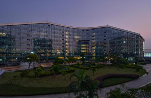 a large building with a park in front of it at Hyatt Place Shenzhen Airport in Bao'an