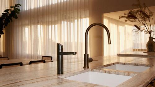 a kitchen with a sink and a counter top at Escape to Summer, Bilgola Plateau IH Luxe in Bilgola