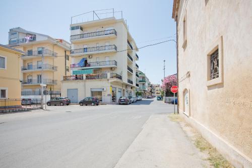an empty city street with a stop sign and buildings at Il Quadrato Bed and Breakfast in Marina di Schiavonea