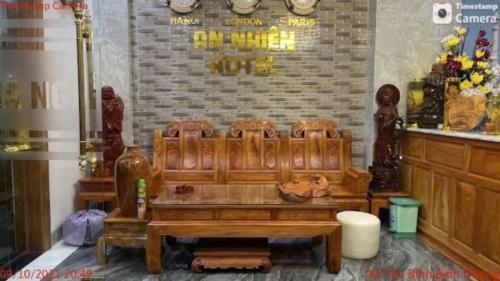 a large wooden bench in a store with a table at Khách Sạn An Nhiên in Bến Cát