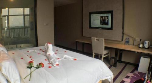 a hotel room with a bed with flowers on it at Lavande Hotel Yichang Railway East Station Branch in Yichang