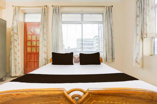 a bedroom with a large bed in front of a window at Hotel O Stay Inn & Restaurant in Gulzārbāgh