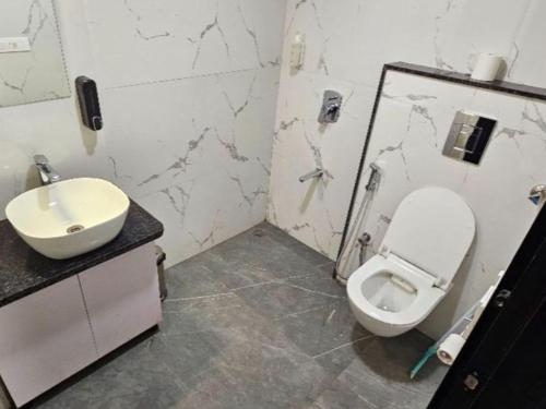a bathroom with a toilet and a sink at The Hosteller Jaipur, MI Road in Jaipur