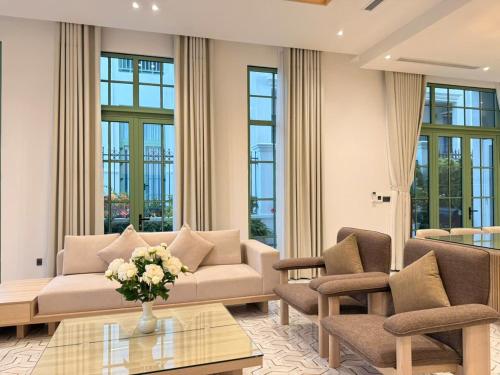 a living room with a couch and chairs and a table at TriKy Village Tropical Bãi Khem in Phu Quoc