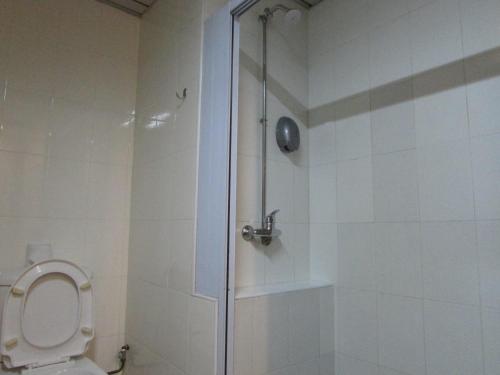a bathroom with a shower and a toilet at Hotel Supreme in Singapore