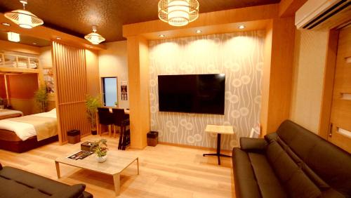 a living room with a couch and a flat screen tv at お宿寧々OyadoNene板橋 池袋3分新宿9分 in Tokyo