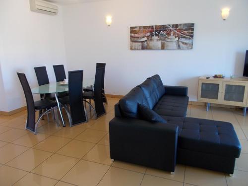 a living room with a couch and a table at T1 e T2 Marina Albufeira apartments in Albufeira