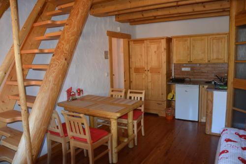 a kitchen and dining room with a wooden table and chairs at Chalupa Ambra in Prachatice