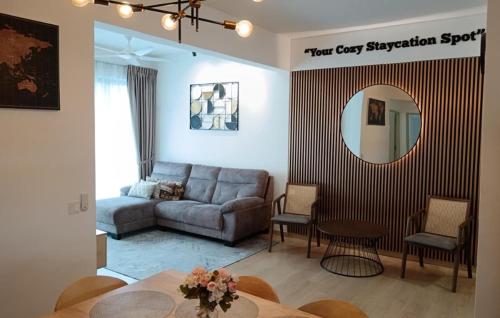 a living room with a couch and a table at Mutiara Melaka Beach Resort by Glex in Tangga Batu