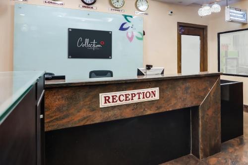a reception desk with a sign that reads reception at Collection O Lotus Grand in Hyderabad