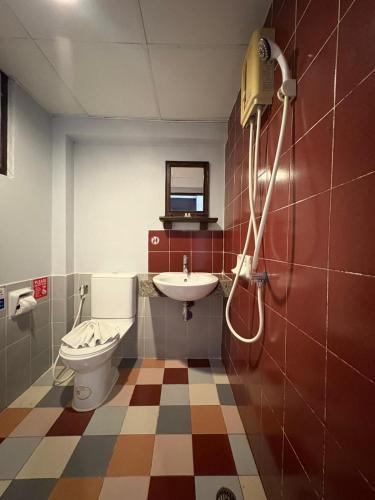 a bathroom with a toilet and a sink at LAY TONG BEACH HOTEL Patong in Patong Beach