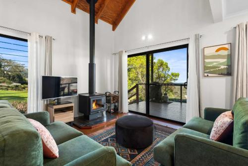 a living room with a couch and a tv and a fireplace at Havenwood Chalet 2 Bedrooms in Ravensbourne