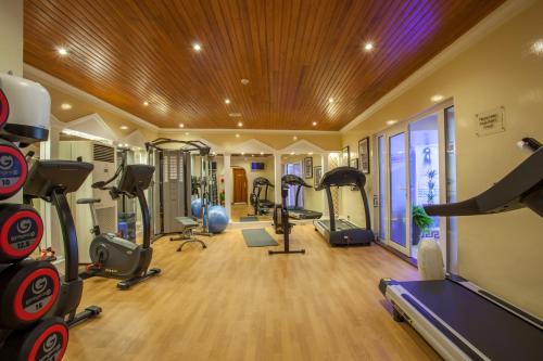 a gym with several treadmills and exercise bikes at Best Western Moores Central Hotel in St Peter Port