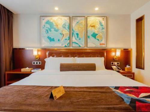 a hotel room with a large bed and a map on the wall at James Joyce Coffetel Guilin Railway Station Xiangbi Mountain Liangjiang Sihu Wharf in Guilin
