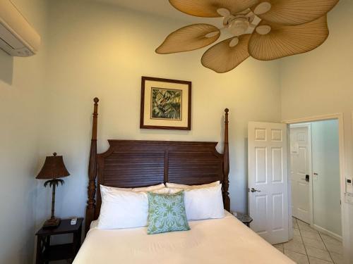 a bedroom with a bed with a ceiling fan at Half Off Bed & Breakfast Suite Steps from Beach with AC in Napili-Honokowai