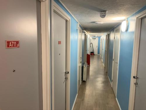 a corridor of a hospital with blue walls and a long hallway at Deanery Student Residence in Southampton