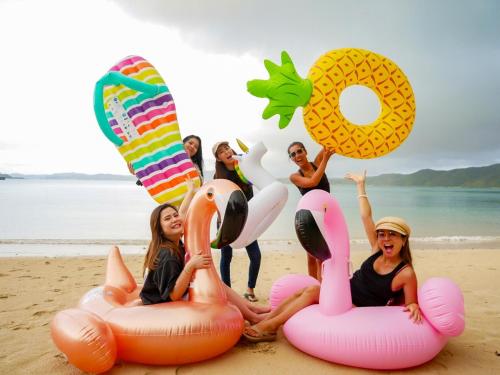 a group of people sitting on the beach with inflatables at Le GRAND BLEU - Vacation STAY 31506v in Akaoki