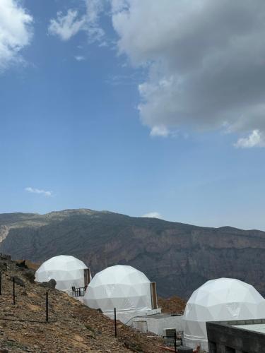 a group of domes on top of a mountain at Grand canyon domes Jabal shams in Sa‘ab Banī Khamīs